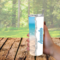 Woman holding calm beach tumbler outdoors dreaming of a beachy getaway.
